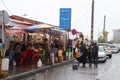 Group of people walking in the street next to Astara's restaurant full of people