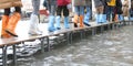 people walks on the footbridge in Venice in Italy with colored p Royalty Free Stock Photo