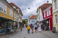 A group of people walks a vacant cobblestone street in the city center of Bergen, Norway after a rainstorm Royalty Free Stock Photo