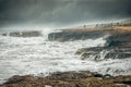 A group of people watching ocean waves Royalty Free Stock Photo