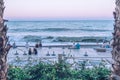 A group of people watching the waves in the evening at sunset. The beach, moment of reflection. Royalty Free Stock Photo