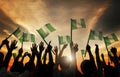 Group of People Waving Flag of Nigeria in Back Lit Royalty Free Stock Photo