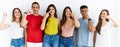 Group of people wearing casual clothes standing over isolated background pointing with hand finger to face and nose, smiling Royalty Free Stock Photo