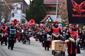 Group of people wearing colorful costumes are marching on a traditional fool's carnival parade