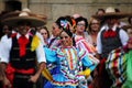 a group of people are wearing mexican clothes and hats at a parade