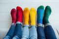 A group of people wearing multi-colored mismatched socks. Odd socks day, anti-bullying week social concept. Down syndrome