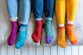 A group of people wearing multi-colored mismatched socks. Odd socks day, anti-bullying week social concept. Down syndrome