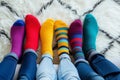 A group of people wearing multi-colored mismatched socks. Odd socks day, anti-bullying week social concept. Down syndrome