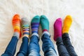 A group of people wearing multi-colored mismatched socks. Odd socks day, anti-bullying week social concept. Down syndrome