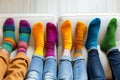 A group of people wearing multi-colored mismatched socks. Odd socks day, anti-bullying week social concept. Down syndrome