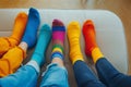 A group of people wearing multi-colored mismatched socks. Odd socks day, anti-bullying week social concept. Down syndrome