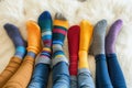 A group of people wearing multi-colored mismatched socks. Odd socks day, anti-bullying week social concept. Down syndrome