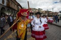 A group of people wearing traditional clothes and masks during the Huaylia on Christmas day