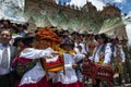 A group of people wearing traditional clothes and masks during the Huaylia on Christmas day in front of the Cuzco Cathedral
