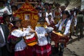 A group of people wearing traditional clothes and masks during the Huaylia on Christmas day in front of the Cuzco Cathedral