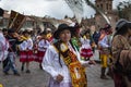 A group of people wearing traditional clothes and masks during the Huaylia on Christmas day at the Plaza de Armas square in the ci