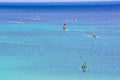 A group of people are windsurfing in the ocean Royalty Free Stock Photo