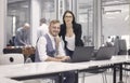 Group of people, working on laptop smiling, looking to camera, some relaxing having fun playing table football, indoors modern Royalty Free Stock Photo