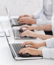 Group of people working with laptops in office