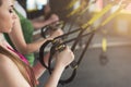 Group performing TRX training in gym