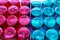 Group of perfume bottles colourful blue and pink top view . Bottle Caps