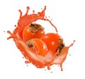 group of persimmons surrounded by splashes of fruit juice Royalty Free Stock Photo