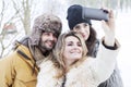 Group of person taking selfie in winter forest Royalty Free Stock Photo