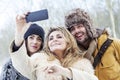 Group of person taking selfie in winter forest Royalty Free Stock Photo