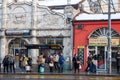 Group of persons, young and old, men and women, waiting their bus at a stop in Belgrade wearing face mask protective equipement