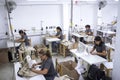 Group of Peruvian workers with sewing machine making alterations to clothes.