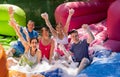 Cheerful men and women playing in foam pool in amusement park Royalty Free Stock Photo