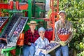 Photo of plantation workers and crop collecting machine Royalty Free Stock Photo