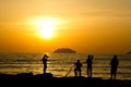 A group of photographers in action during a sunset in Tanjung Aru beach