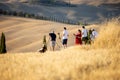 Group of photographers waiting for a golden hour to photograph iconic summer landscape of Toscana. Royalty Free Stock Photo