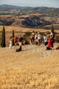 Group of photographers waiting for a golden hour to photograph iconic summer landscape of Toscana.