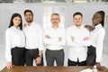 Group picture of happy diverse multiethnic young businesspeople in white shirts posing together at workplace in office Royalty Free Stock Photo