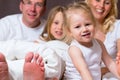 Group picture of a young family in Bed