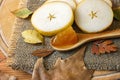 Group of pieces of pear on a wooden board with wooden spoon with pear jam and autumn leaves. Autumn still life. Royalty Free Stock Photo