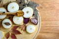 Group of pieces of pear on a wooden board with wooden spoon with pear jam and autumn leaves. Autumn still life. Royalty Free Stock Photo