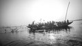 Pilgrims approaching the East bank of the sacred Ganges river by boat at sunrise in Varanasi, Uttar Pradesh, India. Royalty Free Stock Photo