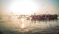 Pilgrims approaching the East bank of the sacred Ganges river by boat at sunrise in Varanasi, Uttar Pradesh, India. Royalty Free Stock Photo