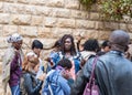 A group of pilgrims believers make a mass prayer near the outer walls of Dormition Abbey in old city of Jerusalem, Israel