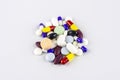 Group of pills, capsules and other coloful medications over white background