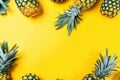 A group of pineapples on a yellow background. AI generative image . A lot of copy space. Royalty Free Stock Photo