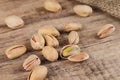 Group of pistachios on a wooden table.