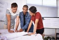 Group, planning and architects with blueprint for construction, discussion and serious in creative startup Royalty Free Stock Photo