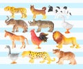 Group of plastic animal doll on color background