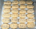 Group of plated whole grain rolls with poppy seeds unbaked