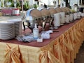 Tableware, stack of white plates, cup  set on table prepared for buffet or party. Royalty Free Stock Photo