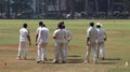 A group of players of the same cricket team gathered on the ground. Royalty Free Stock Photo